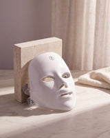GAIA HALO LED mask switched off, resting on travertine and marble