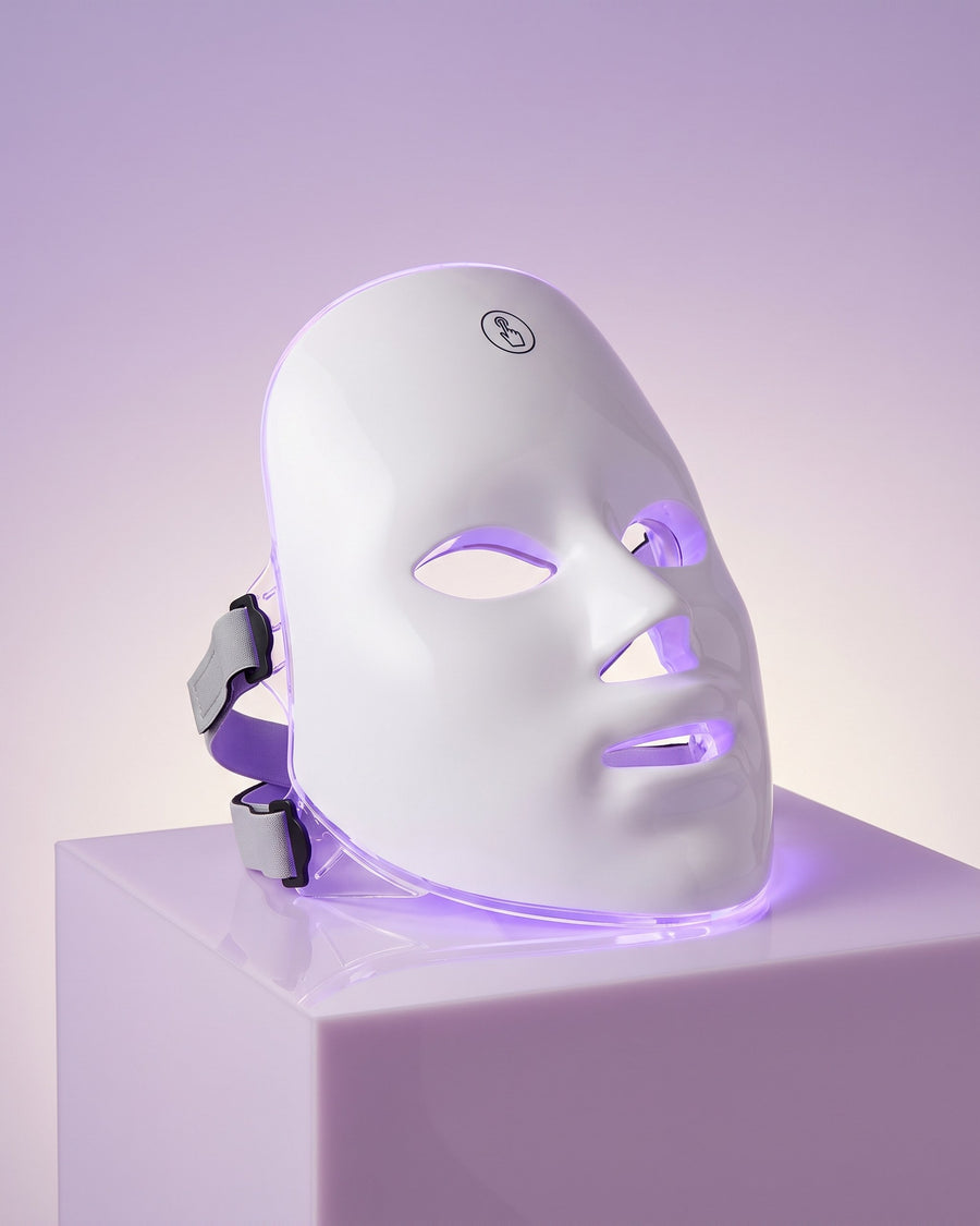 GAIA HALO LED mask in violet light mode on a lilac pedestal